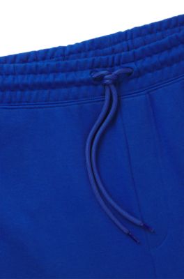 Pantalones de ch&aacute;ndal en felpa de algod&oacute;n con parche de logo azul, Celeste
