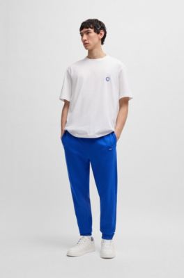 Pantalones de ch&aacute;ndal en felpa de algod&oacute;n con parche de logo azul, Celeste