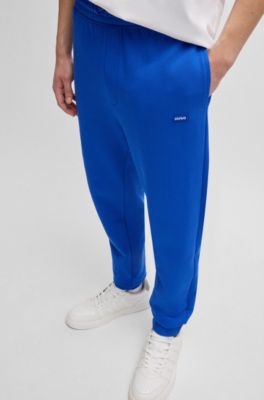 Pantalones de ch&aacute;ndal en felpa de algod&oacute;n con parche de logo azul, Celeste
