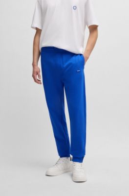 Pantalones de ch&aacute;ndal en felpa de algod&oacute;n con parche de logo azul, Celeste