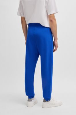 Pantalones de ch&aacute;ndal en felpa de algod&oacute;n con parche de logo azul, Celeste