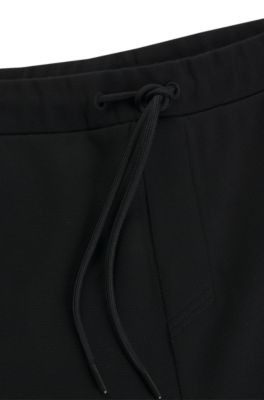Tracksuit bottoms with mirror-effect logo, Black
