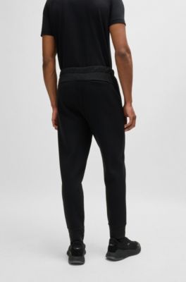 Tracksuit bottoms with mirror-effect logo, Black