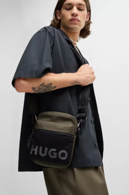 Reporter bag with contrast logo and mesh overlay