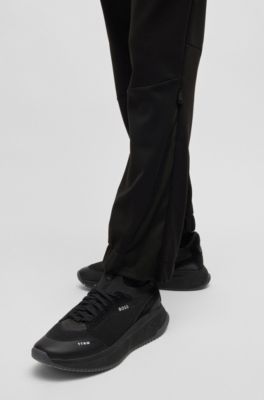 Pantalones de ch&aacute;ndal de forro polar aglomerado con detalle de logo, Negro