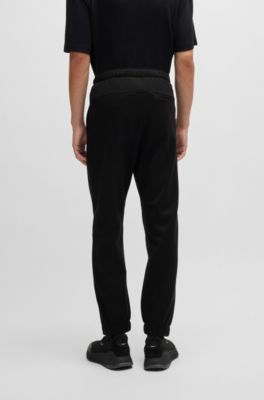 Pantalones de ch&aacute;ndal de forro polar aglomerado con detalle de logo, Negro