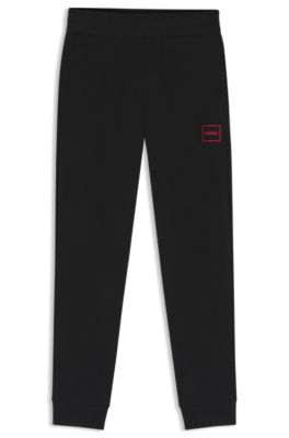 Logo-print tracksuit bottoms in stretch cotton, Black