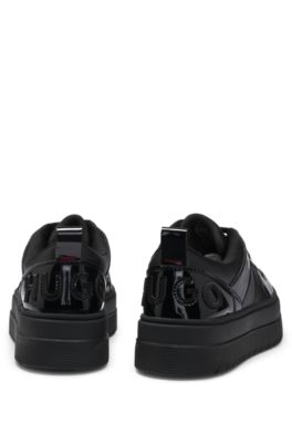 Platform-sole lace-up trainers with patent details, Black