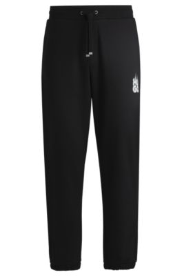 Pantalones de ch&aacute;ndal en felpa de algod&oacute;n con logo ahumado, Negro