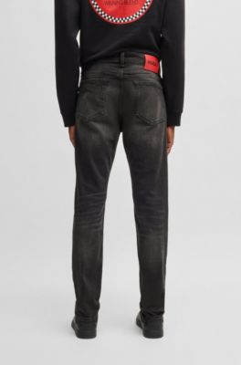 Jeans slim fit de denim el&aacute;stico negro, Negro