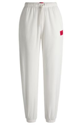 Tracksuit bottoms with red logo label, White