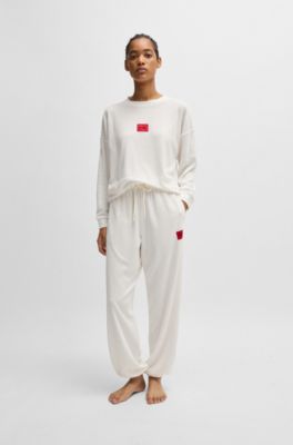 Tracksuit bottoms with red logo label, White