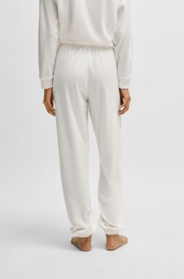 Tracksuit bottoms with red logo label, White