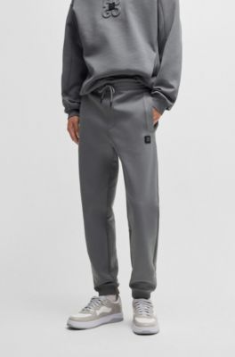 Stacked-logo tracksuit bottoms in a cotton blend, Light Grey