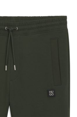 Pantalones de ch&aacute;ndal de algod&oacute;n con logo apilado, Verde oscuro