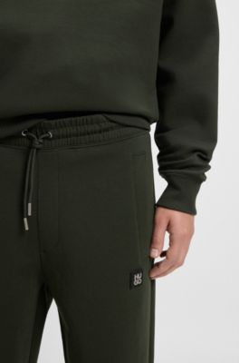 Pantalones de ch&aacute;ndal de algod&oacute;n con logo apilado, Verde oscuro
