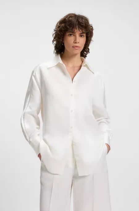 Tailored blouse with crochet-effect trims