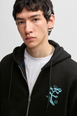 Sweat &agrave; capuche zipp&eacute; en molleton de coton avec motif artistique de la saison, Noir