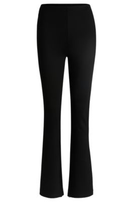 Pantalones relaxed fit en tejido el&aacute;stico con pernera acampanada, Negro
