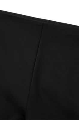 Pantalones relaxed fit en tejido el&aacute;stico con pernera acampanada, Negro