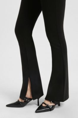 Pantalones relaxed fit en tejido el&aacute;stico con pernera acampanada, Negro