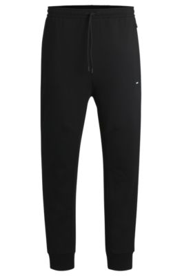 BOSS - Stretch tracksuit bottoms with logo patch - Black