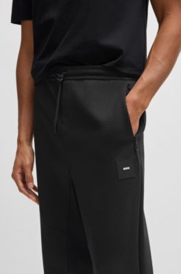 Pantalones de ch&aacute;ndal en algod&oacute;n el&aacute;stico con parche de logo, Negro