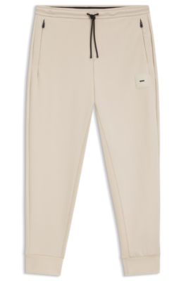 Pantalones de ch&aacute;ndal en algod&oacute;n el&aacute;stico con parche de logo, Beige claro