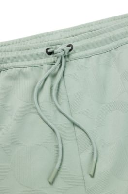 Pantalones de ch&aacute;ndal relaxed fit con c&iacute;rculos tejidos en jacquard, Cal