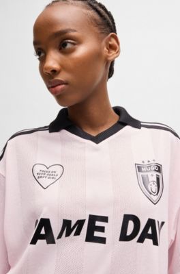 Football-inspired mesh T-shirt with Happy HUGO logo, light pink