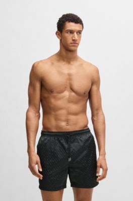 Swim shorts with all-over tonal monograms