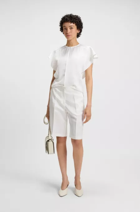 Frill-sleeve blouse with crochet-style trims