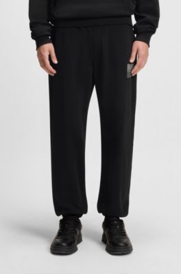Split-logo tracksuit bottoms in cotton terry, Black