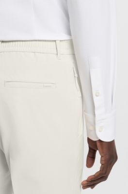 Pantalones slim fit plegables de tejido el&aacute;stico t&eacute;cnico, Blanco