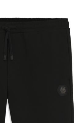Pantalones de ch&aacute;ndal de algod&oacute;n con monograma Double&nbsp;B, Negro