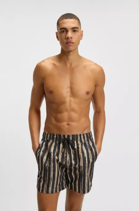 Quick-dry swim shorts with all-over print