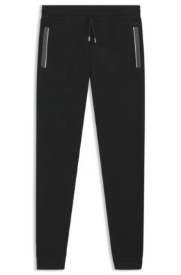 Pantalones de ch&aacute;ndal en algod&oacute;n el&aacute;stico con detalle de bolsillo, Negro