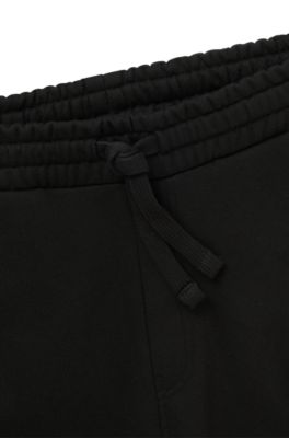 Pantalones de ch&aacute;ndal en felpa de algod&oacute;n con gr&aacute;ficos bordados, Negro