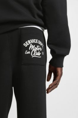 Pantalones de ch&aacute;ndal en felpa de algod&oacute;n con gr&aacute;ficos bordados, Negro