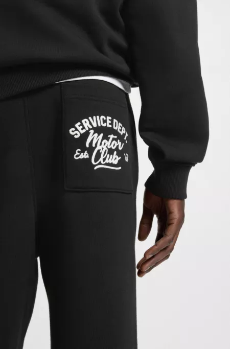 Cotton-terry tracksuit bottoms with embroidered graphics