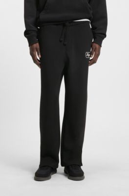 Pantalones de ch&aacute;ndal en felpa de algod&oacute;n con gr&aacute;ficos bordados, Negro