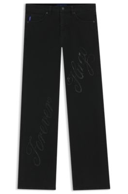 Jeans slim fit en denim con eslogan de logo en pedrer&iacute;a, Negro