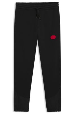 Pantalones de ch&aacute;ndal en mezcla de algod&oacute;n con logo estampado encerado, Negro