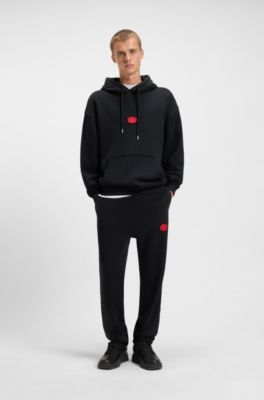 Pantalones de ch&aacute;ndal en mezcla de algod&oacute;n con logo estampado encerado, Negro