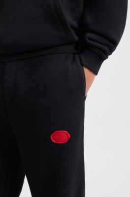 Pantalones de ch&aacute;ndal en mezcla de algod&oacute;n con logo estampado encerado, Negro