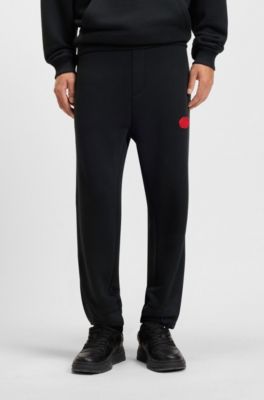 Pantalones de ch&aacute;ndal en mezcla de algod&oacute;n con logo estampado encerado, Negro
