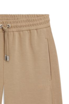Pantalones globo en punto el&aacute;stico con logo bordado, Marr&oacute;n