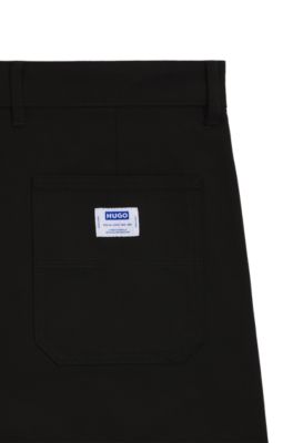 Pantalones regular fit de lona de algod&oacute;n el&aacute;stico, Negro