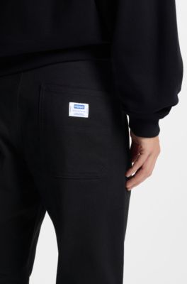 Pantalones regular fit de lona de algod&oacute;n el&aacute;stico, Negro