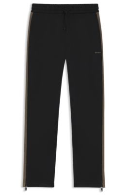 Pantalones de ch&aacute;ndal relaxed fit con cinta de logos, Negro